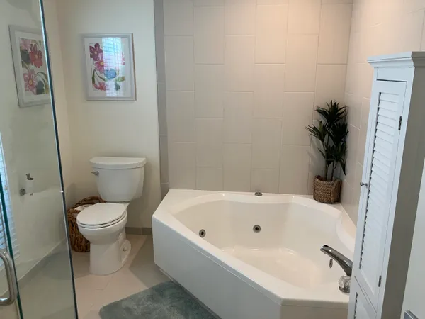 a white bath tub sitting next to a white toilet