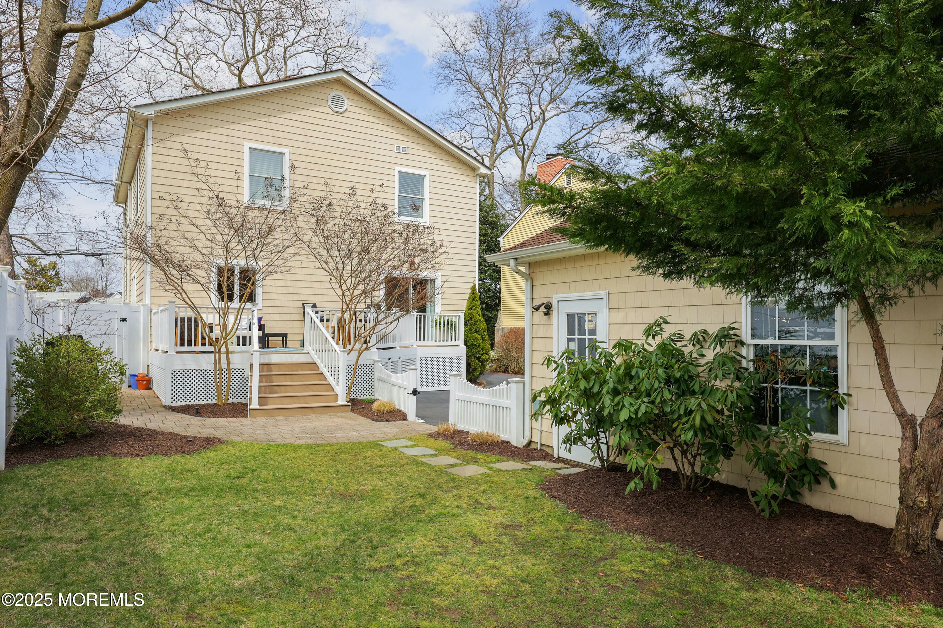 105 Black Point Road Rumson, NJ 07760 - Photo 28 of 33 a view of a house with brick walls and a yard with plants
