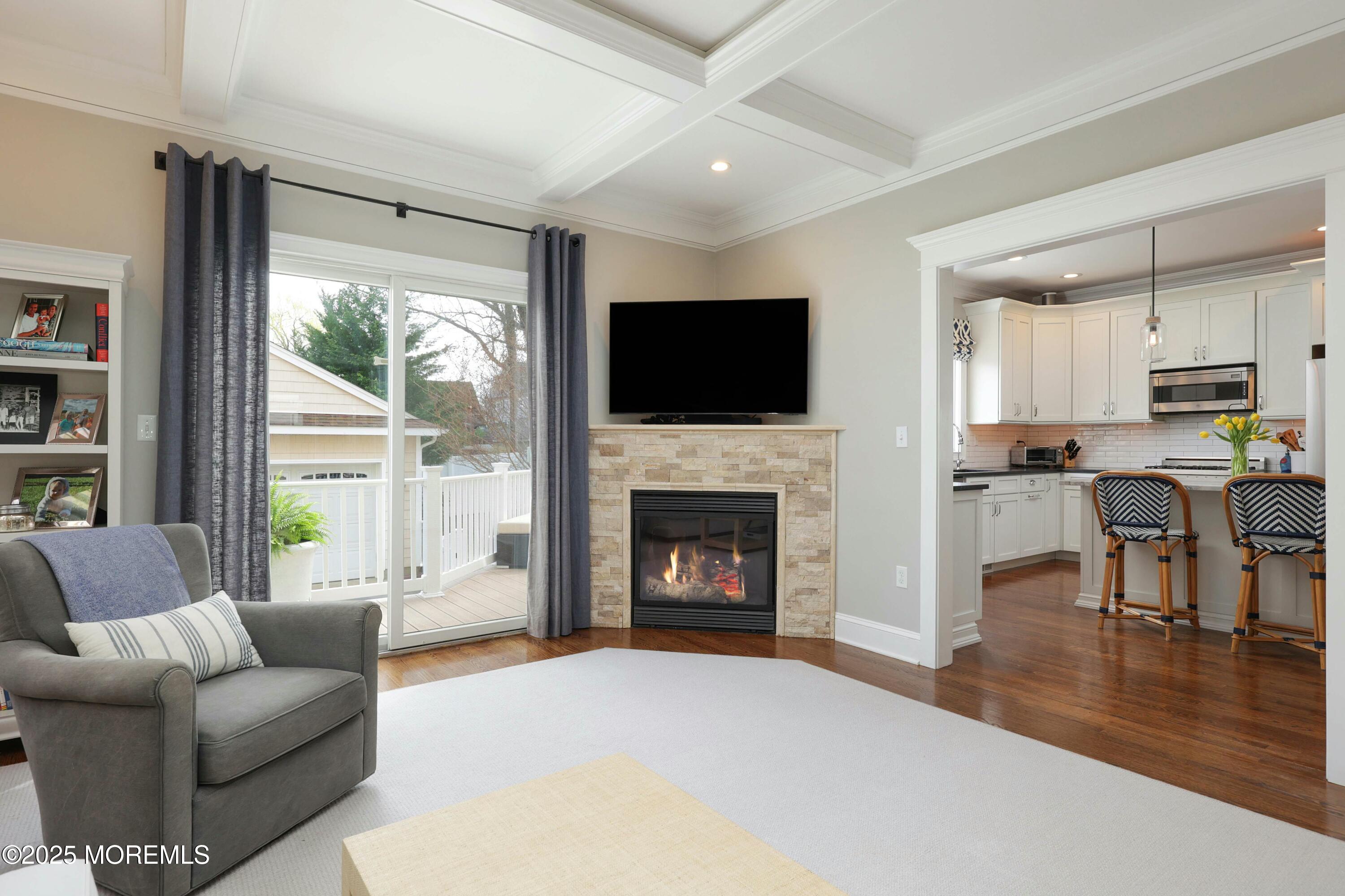 105 Black Point Road Rumson, NJ 07760 - Photo 6 of 33 a living room with furniture a fireplace and a flat screen tv