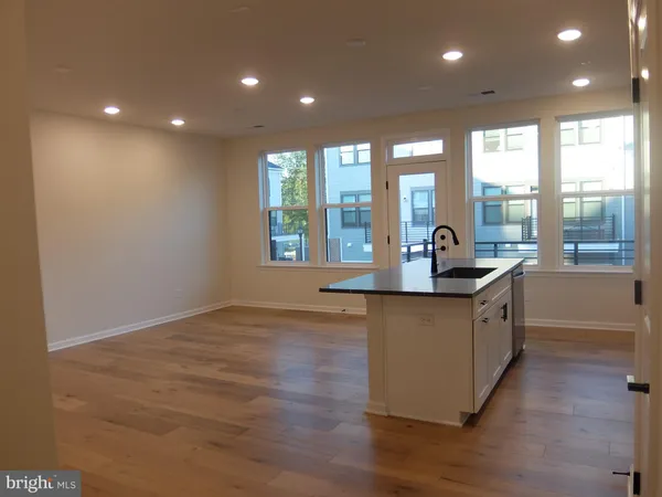 a kitchen with stainless steel appliances granite countertop a sink and a large window