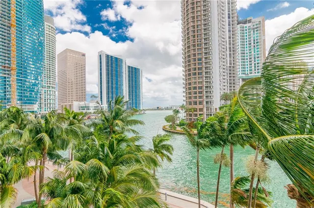 a kitchen with granite countertop a sink a stove and a wooden cabinets
