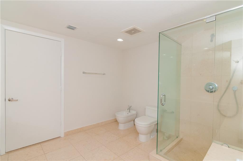 465 Brickell Avenue, Unit BAY 419 Miami, FL 33131 - Photo 29 of 54 a bathroom with a shower and a toilet