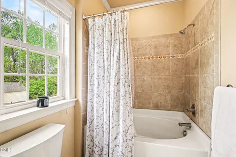 a bathroom with a bathtub and shower