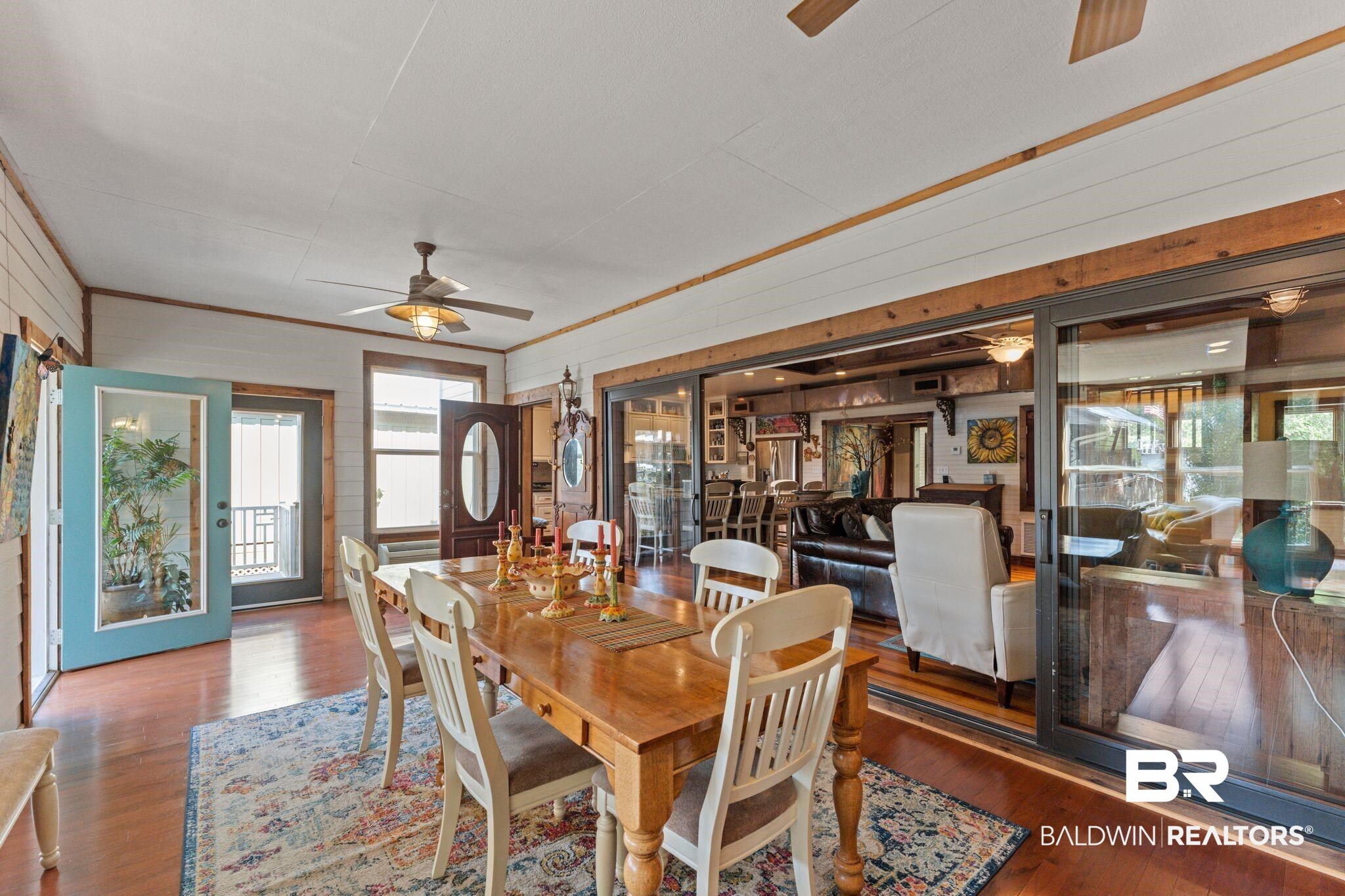 16451 Honey Road Summerdale, AL 36580 - Photo 18 of 55 Dining space with a ceiling fan, dark wood-style floors, ornamental molding, and wooden walls