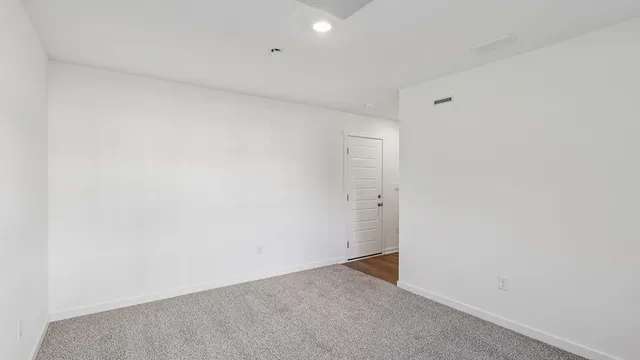 a kitchen with refrigerator a table and chairs
