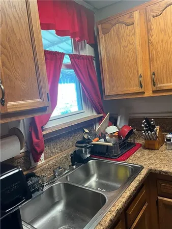 a kitchen with a stove a sink and a cabinets