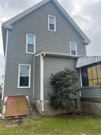 a house that has a large pool in front of it