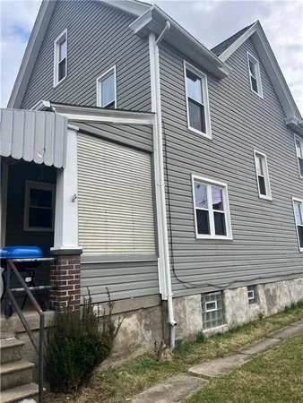 a view of house with backyard space and porch