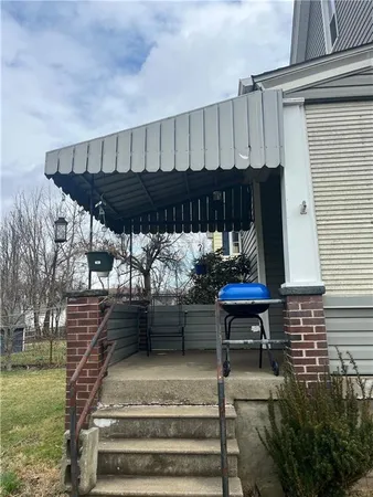a view of a balcony with furniture and wooden floor