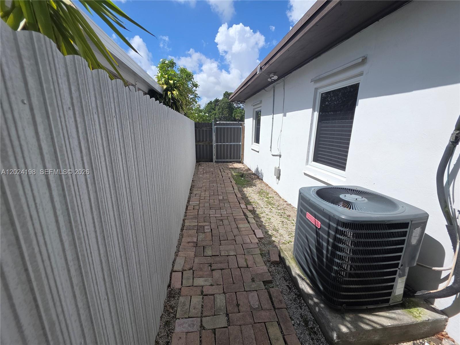 651 East 48th Street Hialeah, FL 33013 - Photo 29 of 52 a view of a balcony with wooden floor and fence