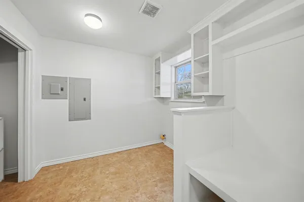 a view of storage and utility room with closet