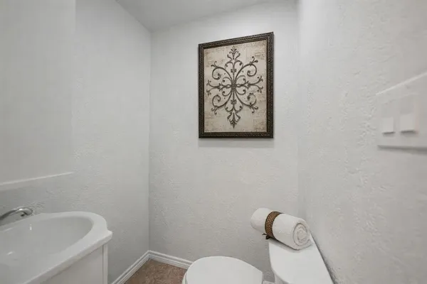 a white toilet sitting next to a bathroom sink