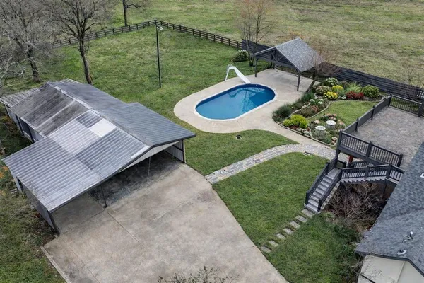 a view of a wooden deck and a backyard
