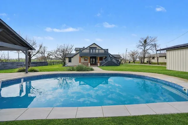 a view of swimming pool with outdoor space and seating area