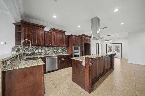 a kitchen with stainless steel appliances granite countertop a stove a sink and a refrigerator