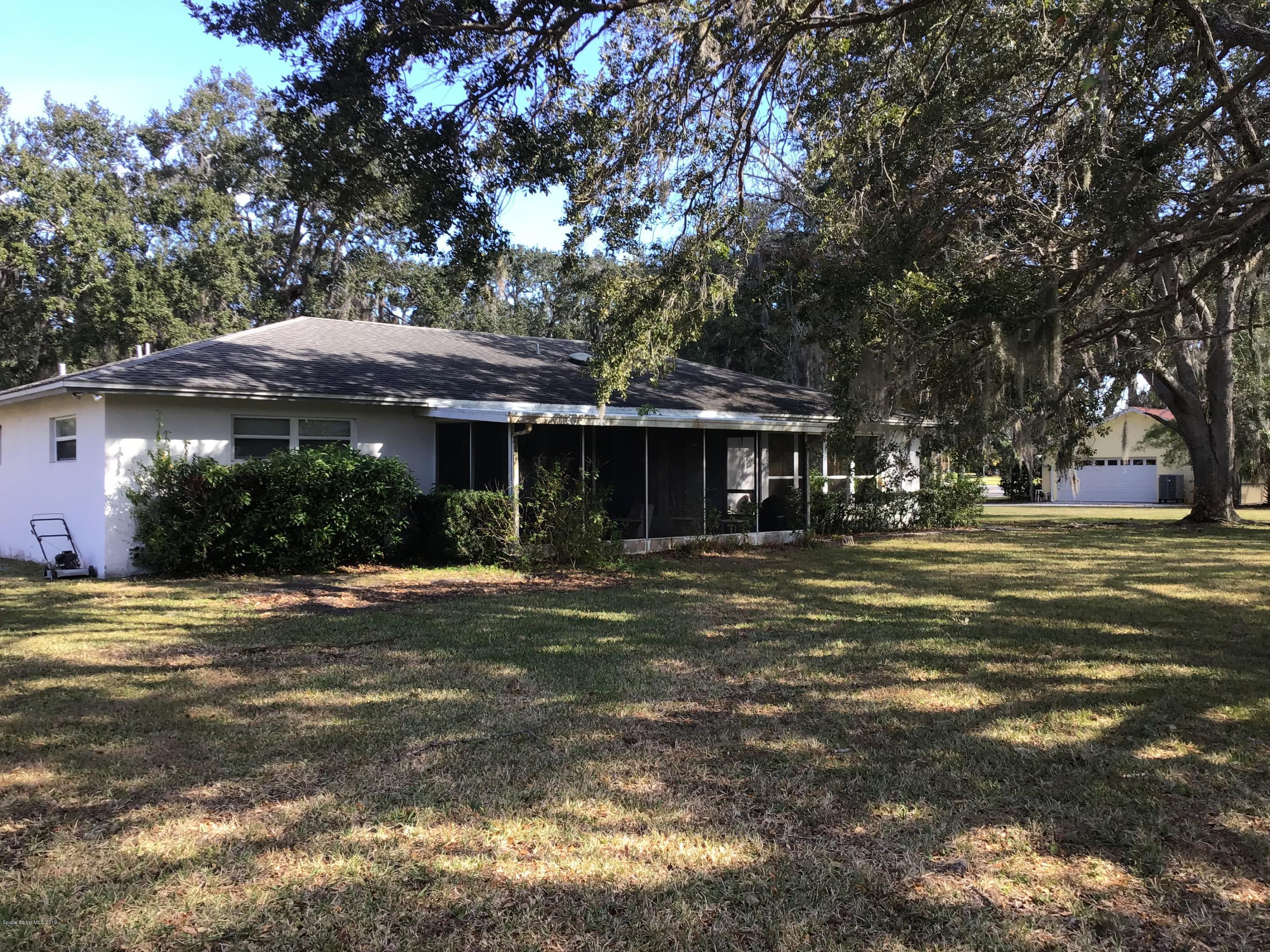 1350 Meadowbrook Road Northeast Palm Bay, FL 32905 - Photo 13 of 55 a front view of a house with a garden