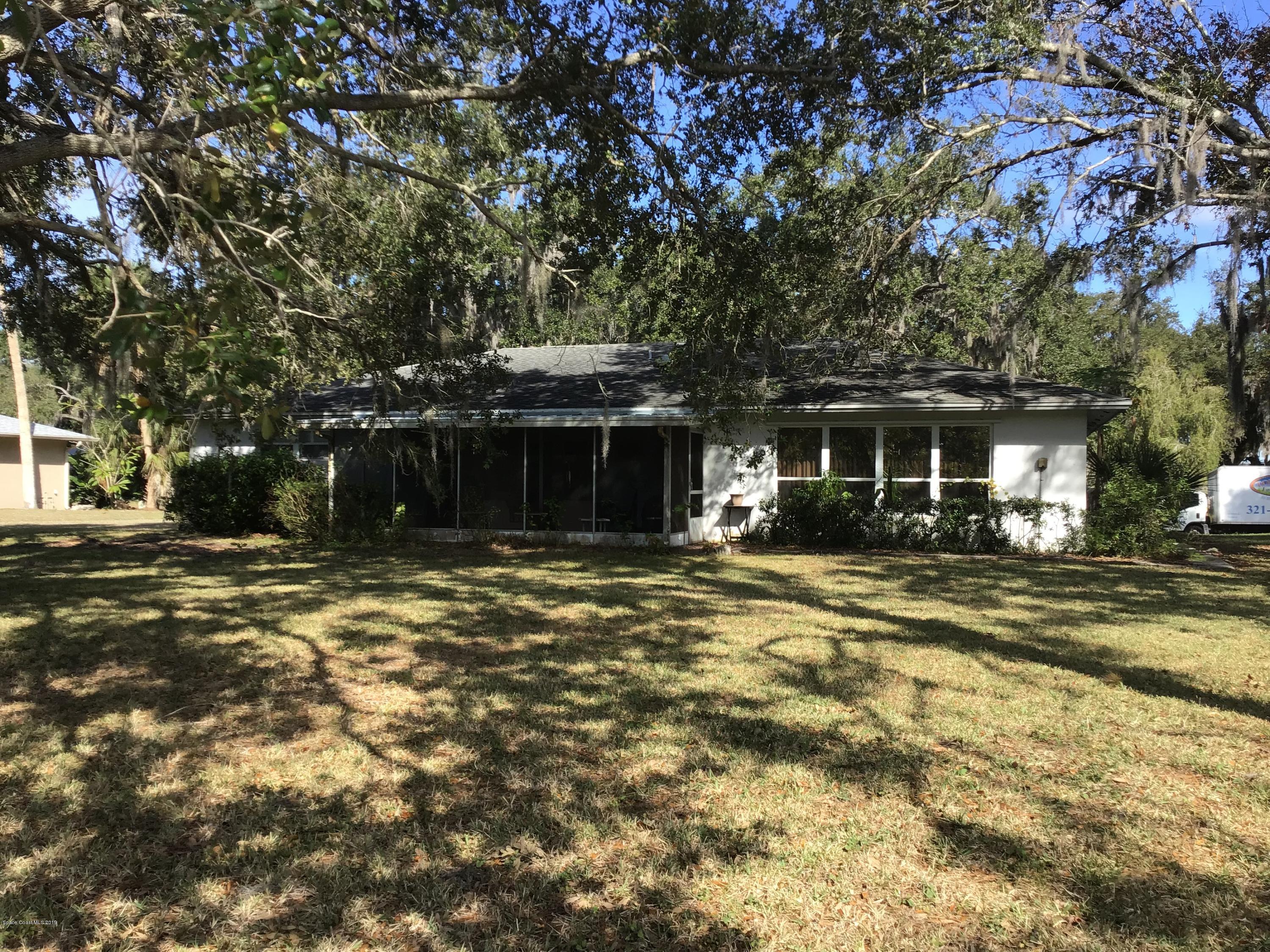 1350 Meadowbrook Road Northeast Palm Bay, FL 32905 - Photo 17 of 55 a front view of a house with a yard