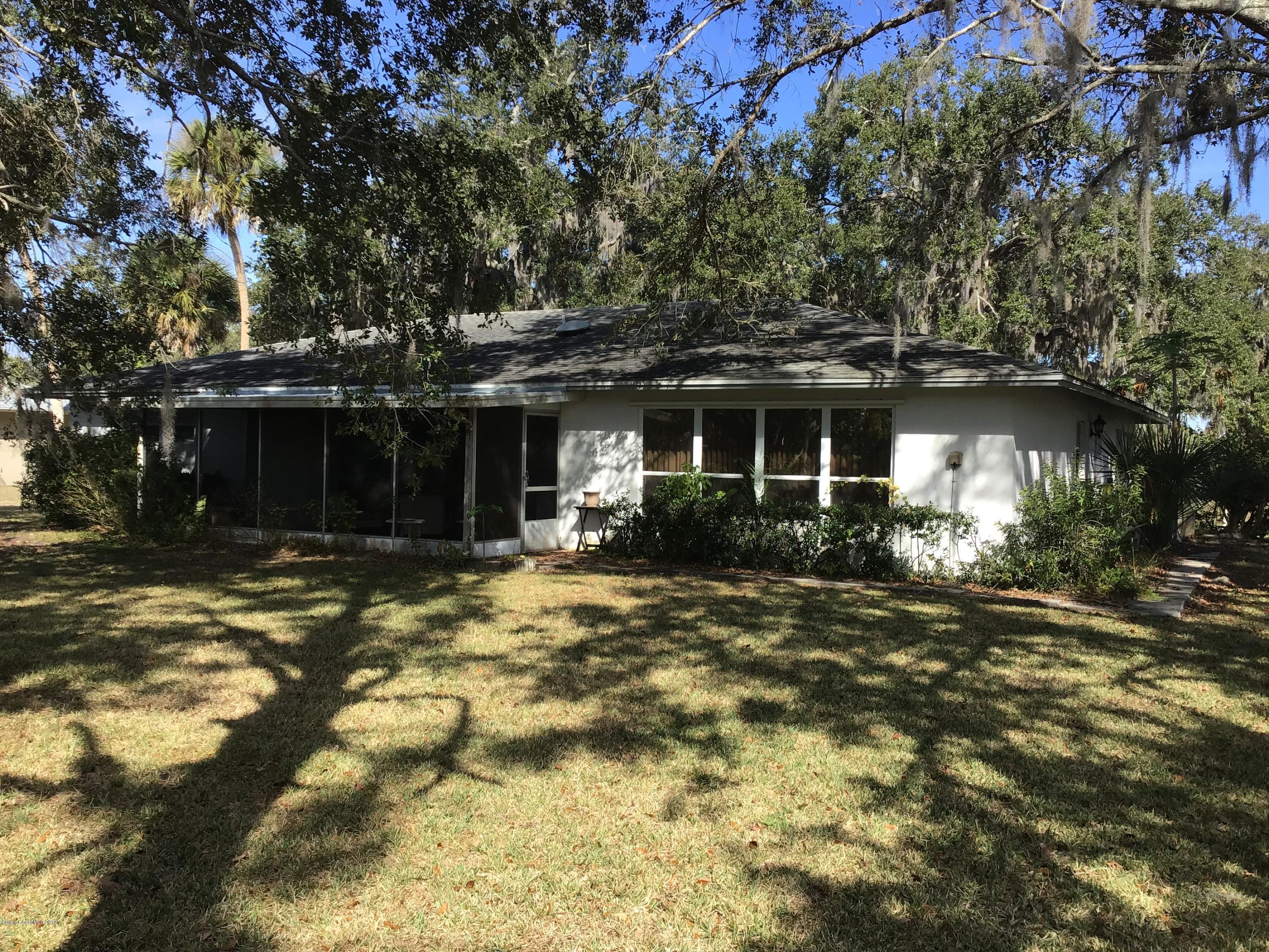 1350 Meadowbrook Road Northeast Palm Bay, FL 32905 - Photo 18 of 55 a front view of a house with a yard