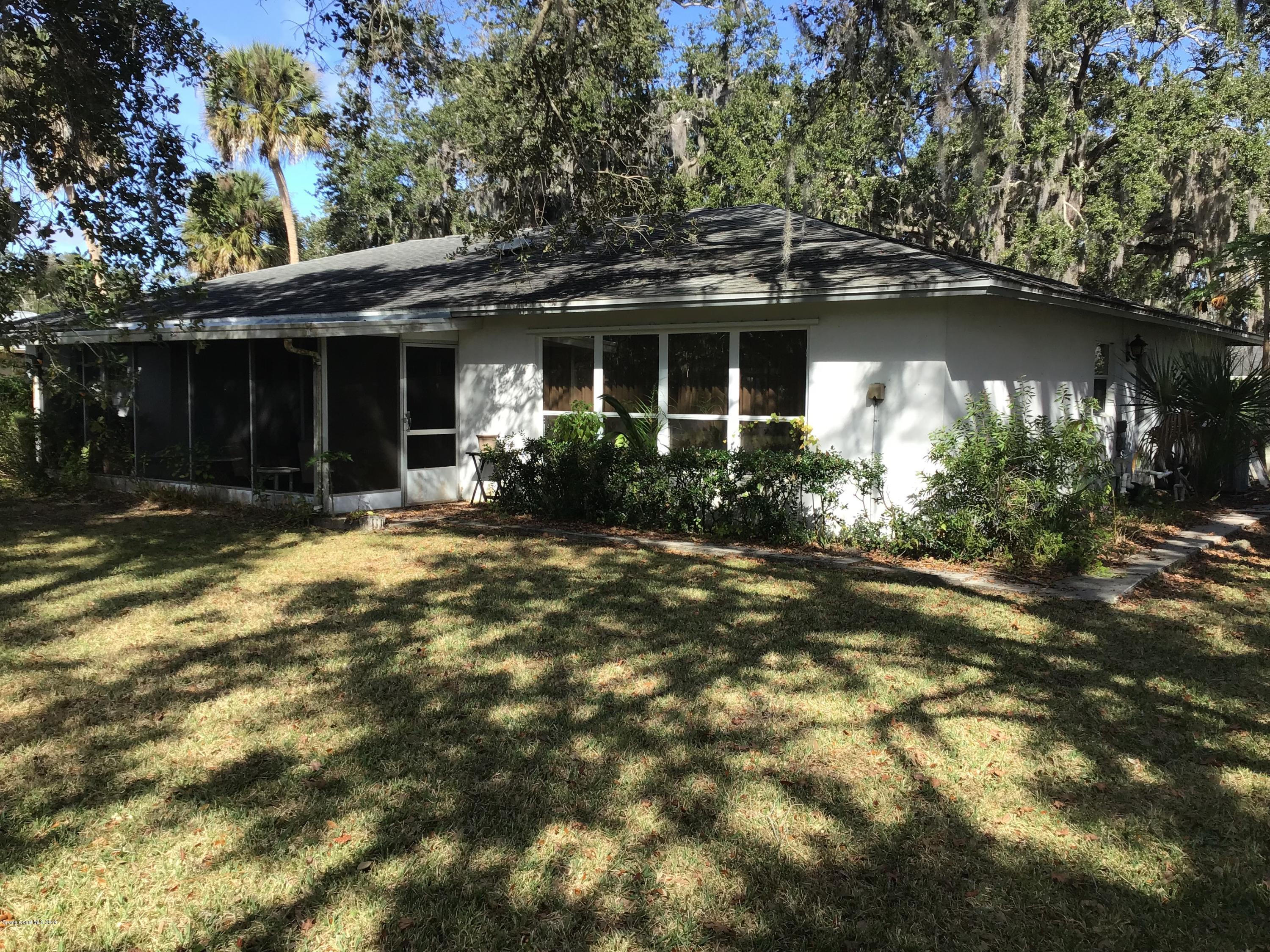 1350 Meadowbrook Road Northeast Palm Bay, FL 32905 - Photo 20 of 55 a front view of a house with a yard