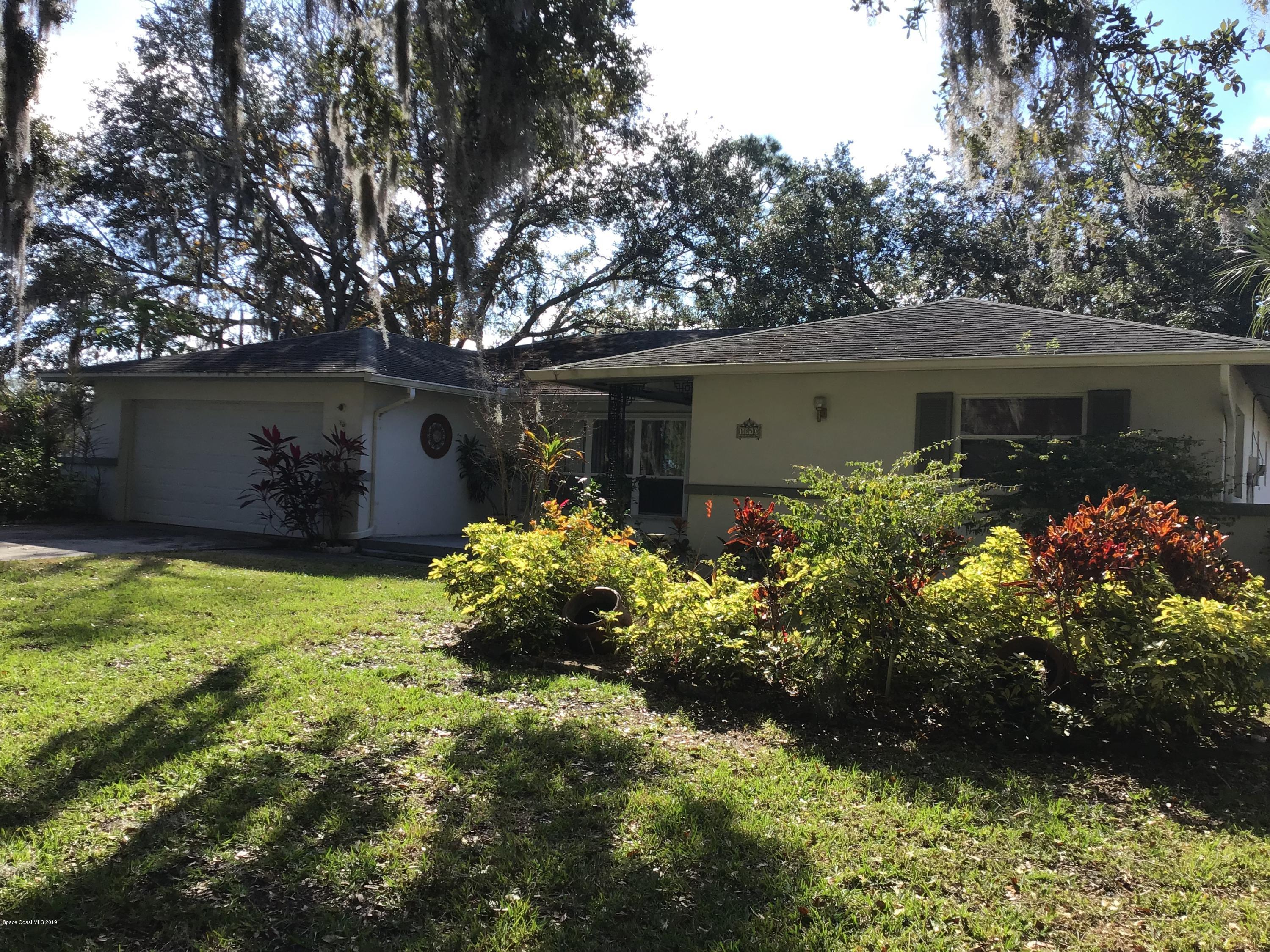 1350 Meadowbrook Road Northeast Palm Bay, FL 32905 - Photo 3 of 55 front view of house with a yard