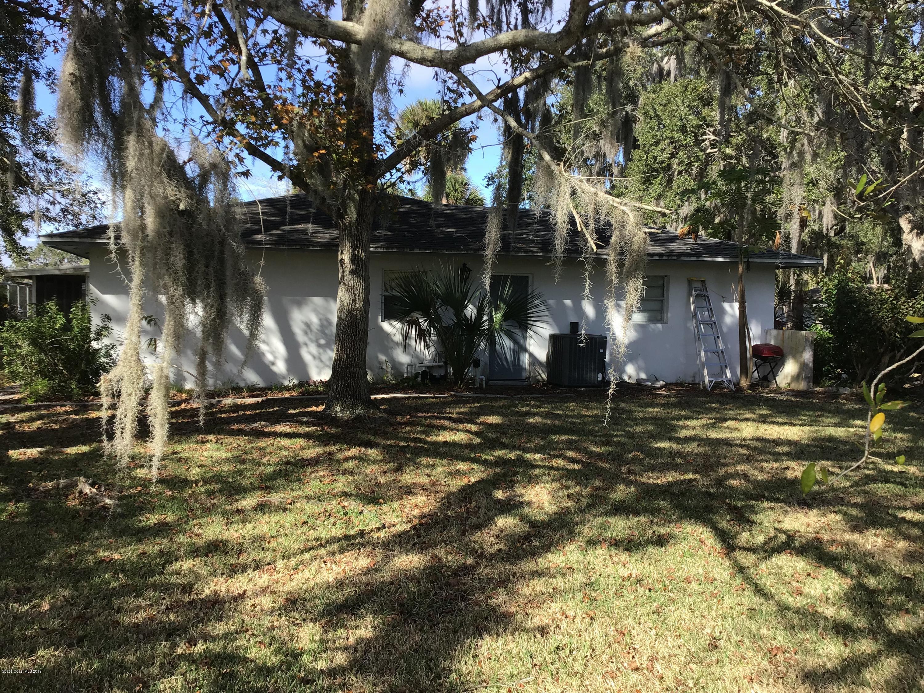 1350 Meadowbrook Road Northeast Palm Bay, FL 32905 - Photo 22 of 55 a backyard of a house with barbeque oven and outdoor seating