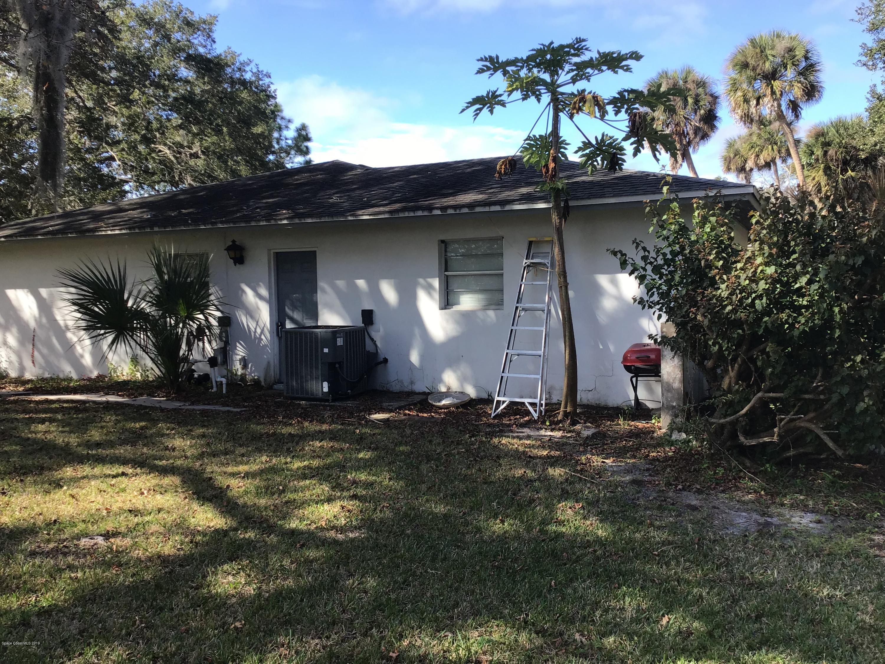 1350 Meadowbrook Road Northeast Palm Bay, FL 32905 - Photo 23 of 55 a view of a house with a yard