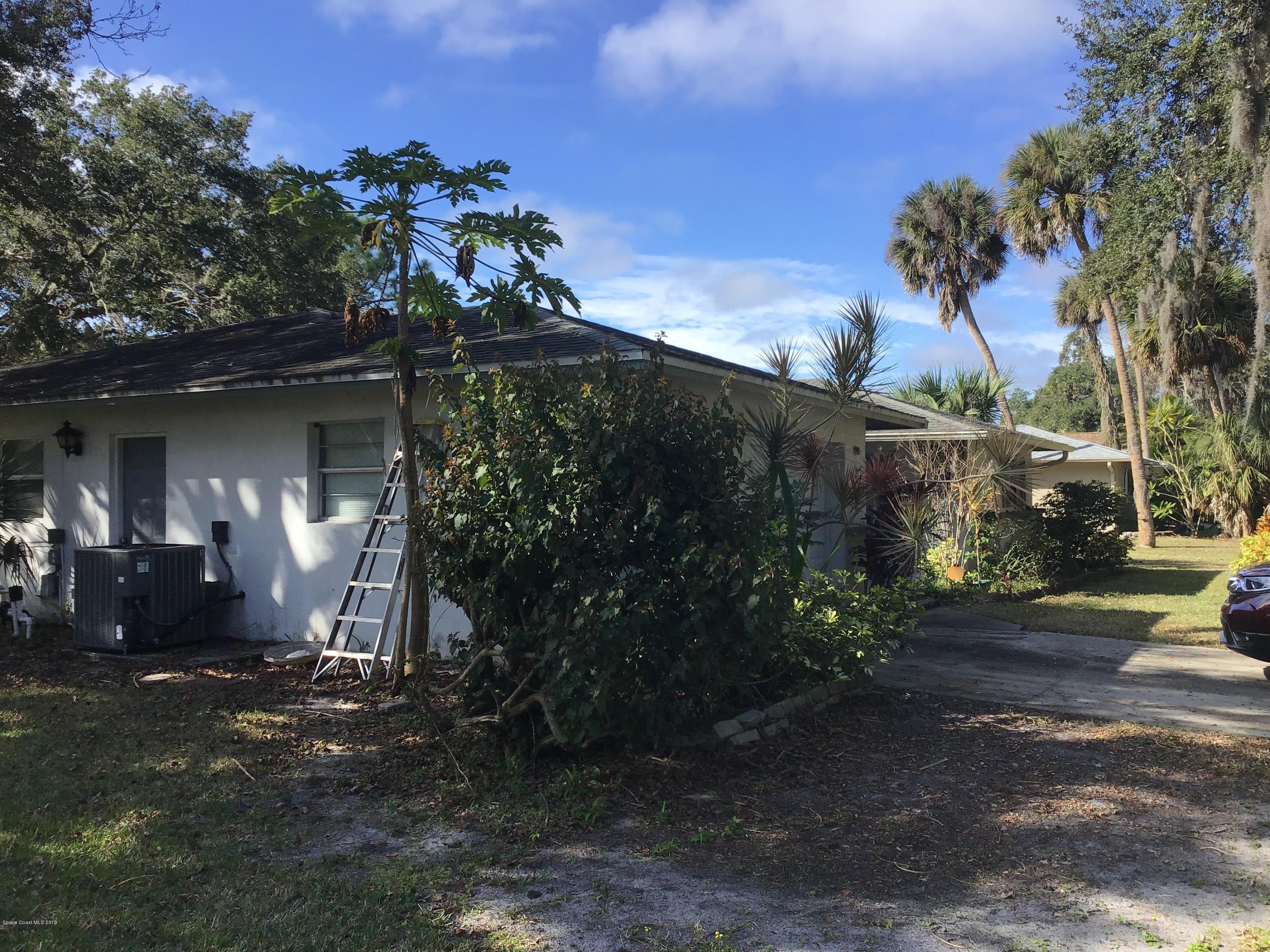 1350 Meadowbrook Road Northeast Palm Bay, FL 32905 - Photo 24 of 55 a front view of a house with a yard
