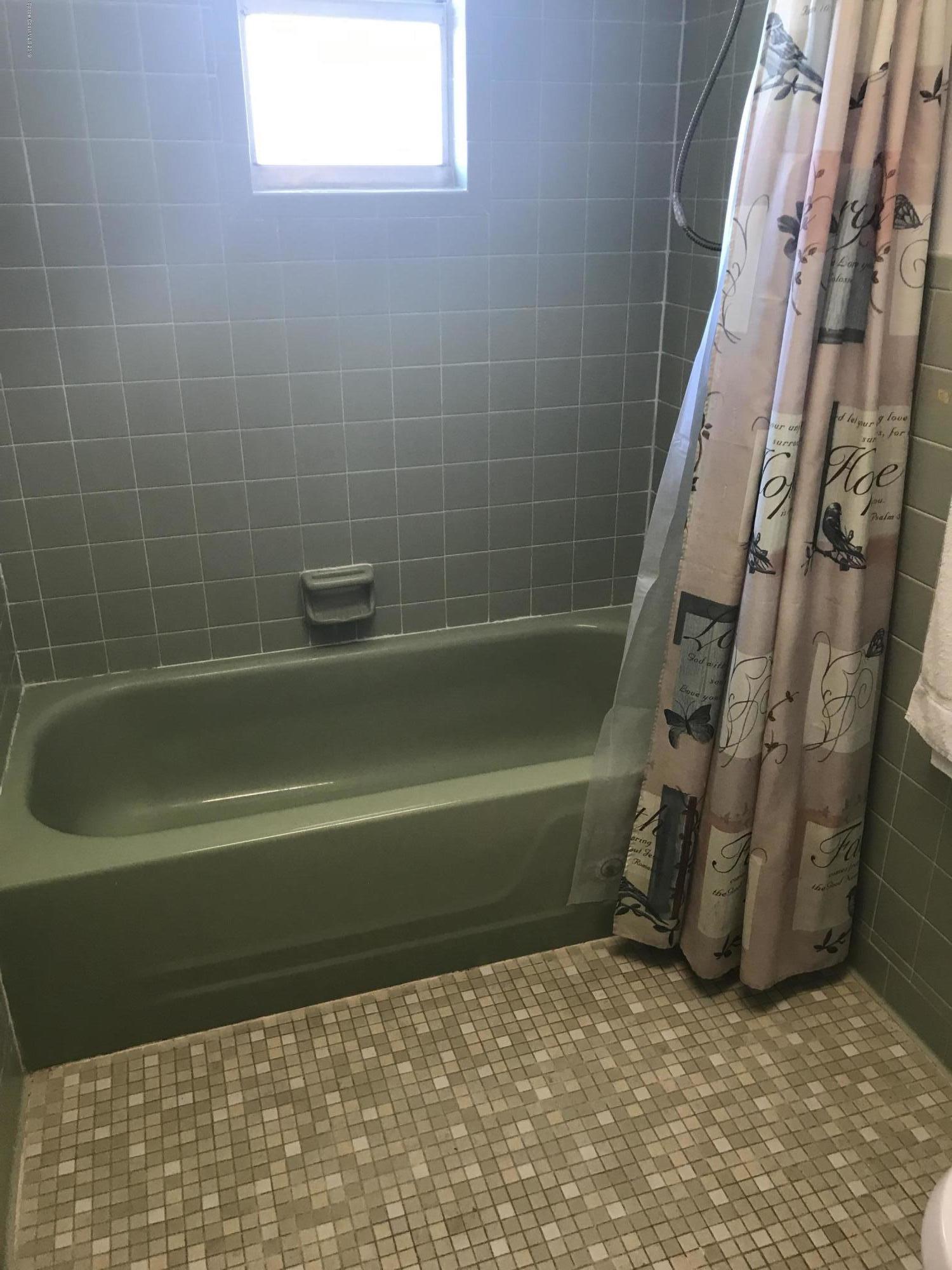 1350 Meadowbrook Road Northeast Palm Bay, FL 32905 - Photo 28 of 55 a bathroom with a bathtub