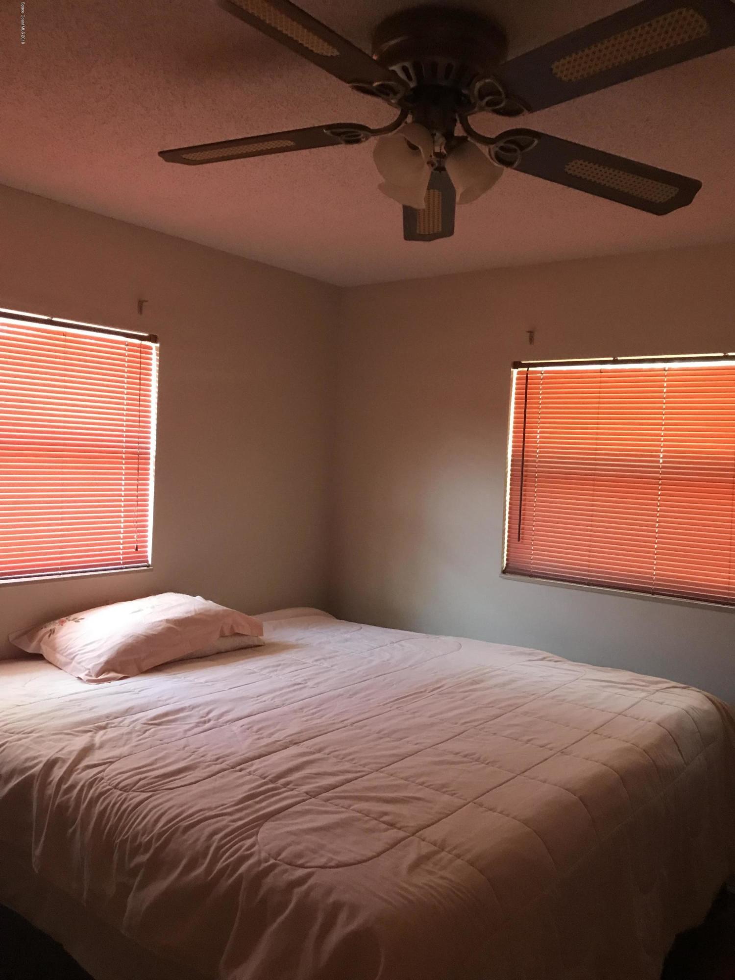 1350 Meadowbrook Road Northeast Palm Bay, FL 32905 - Photo 29 of 55 a bedroom with a bed and a window