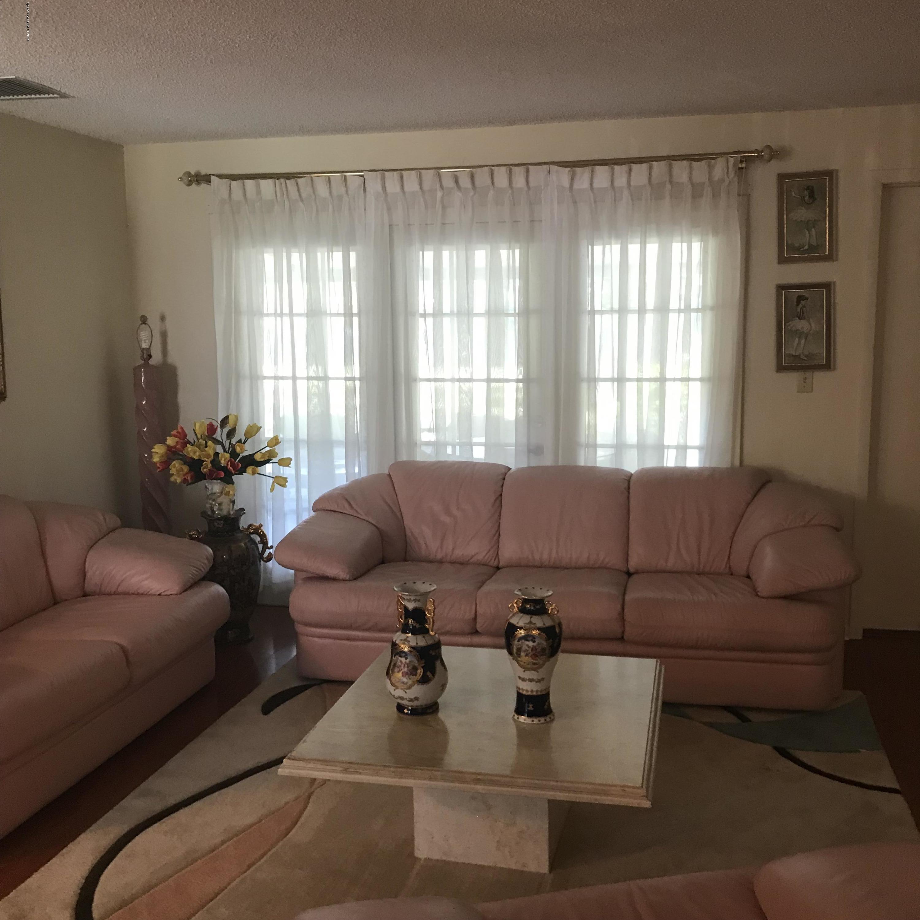 1350 Meadowbrook Road Northeast Palm Bay, FL 32905 - Photo 34 of 55 a living room with furniture and a large window