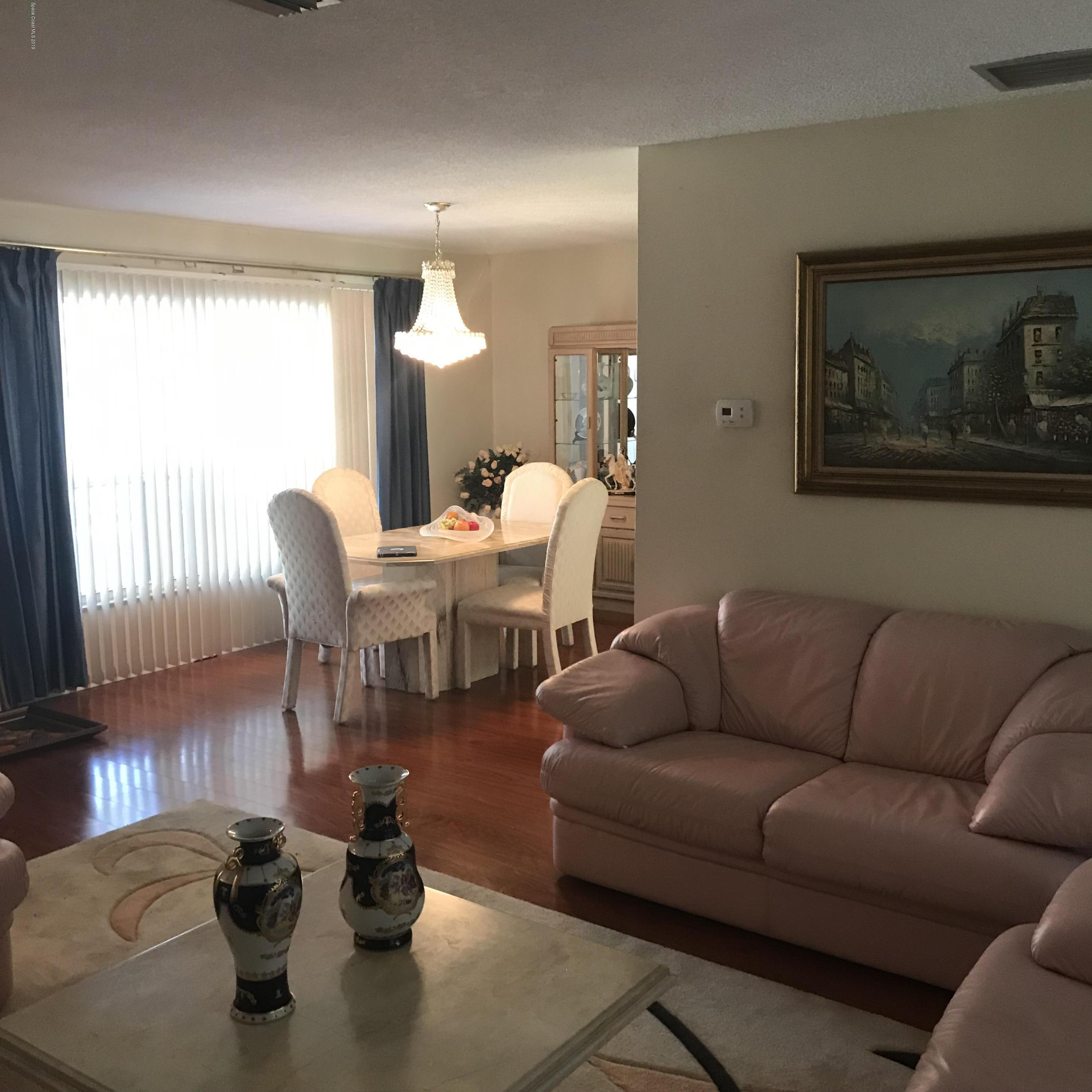 1350 Meadowbrook Road Northeast Palm Bay, FL 32905 - Photo 35 of 55 a living room with furniture and wooden floor