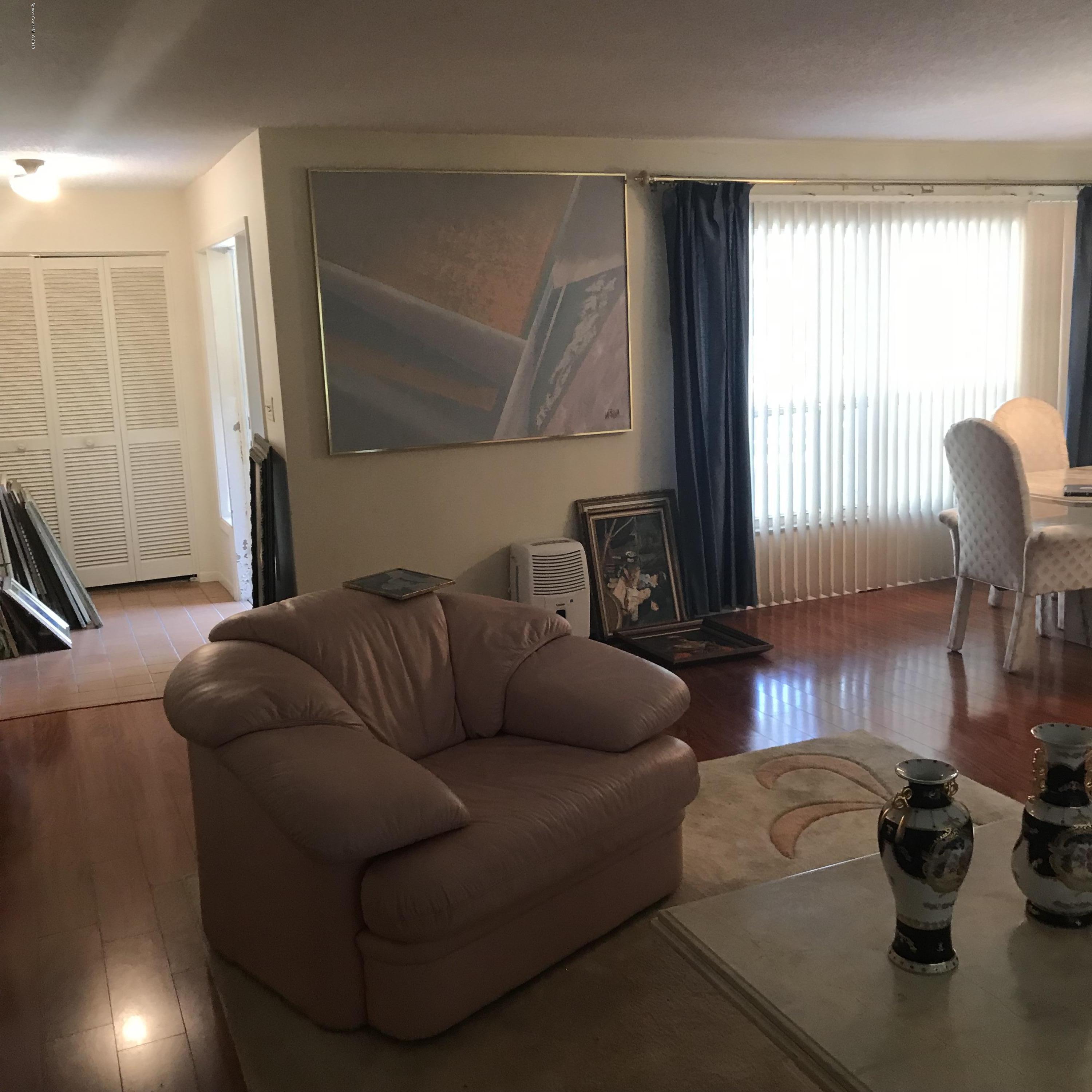 1350 Meadowbrook Road Northeast Palm Bay, FL 32905 - Photo 36 of 55 a living room with furniture and a window