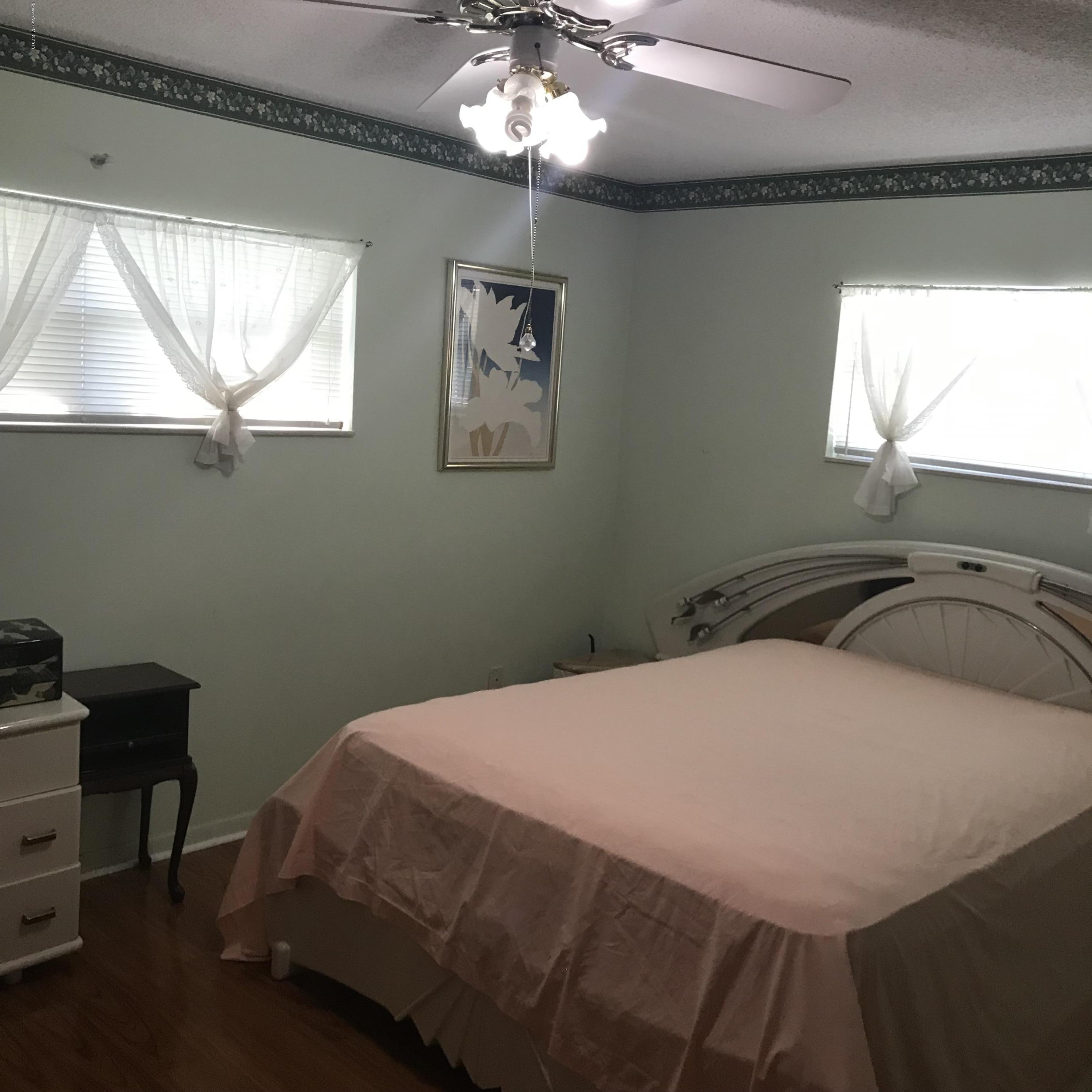 1350 Meadowbrook Road Northeast Palm Bay, FL 32905 - Photo 37 of 55 a bedroom with a bed and a window