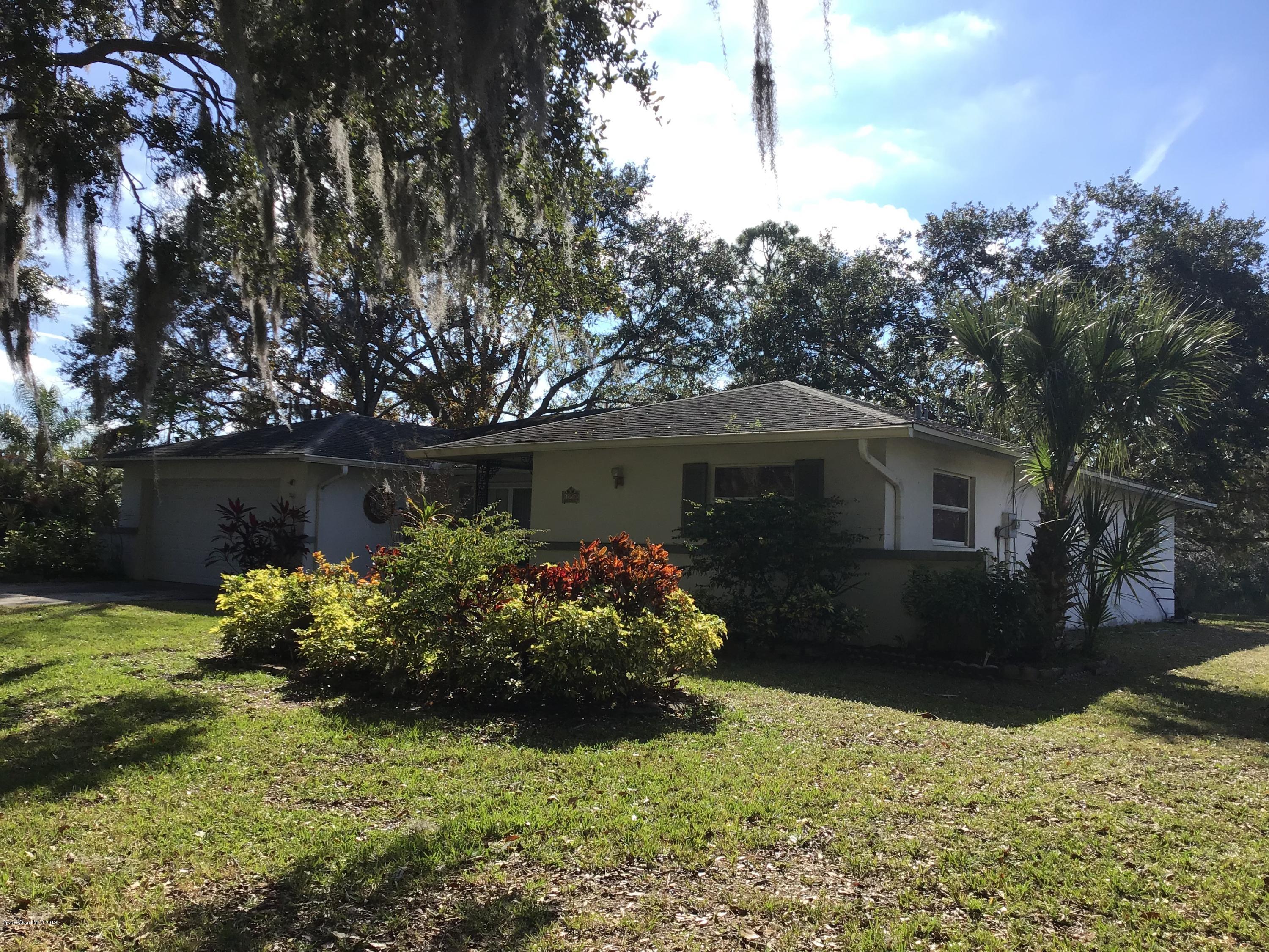 1350 Meadowbrook Road Northeast Palm Bay, FL 32905 - Photo 5 of 55 a front view of house with yard and outdoor seating