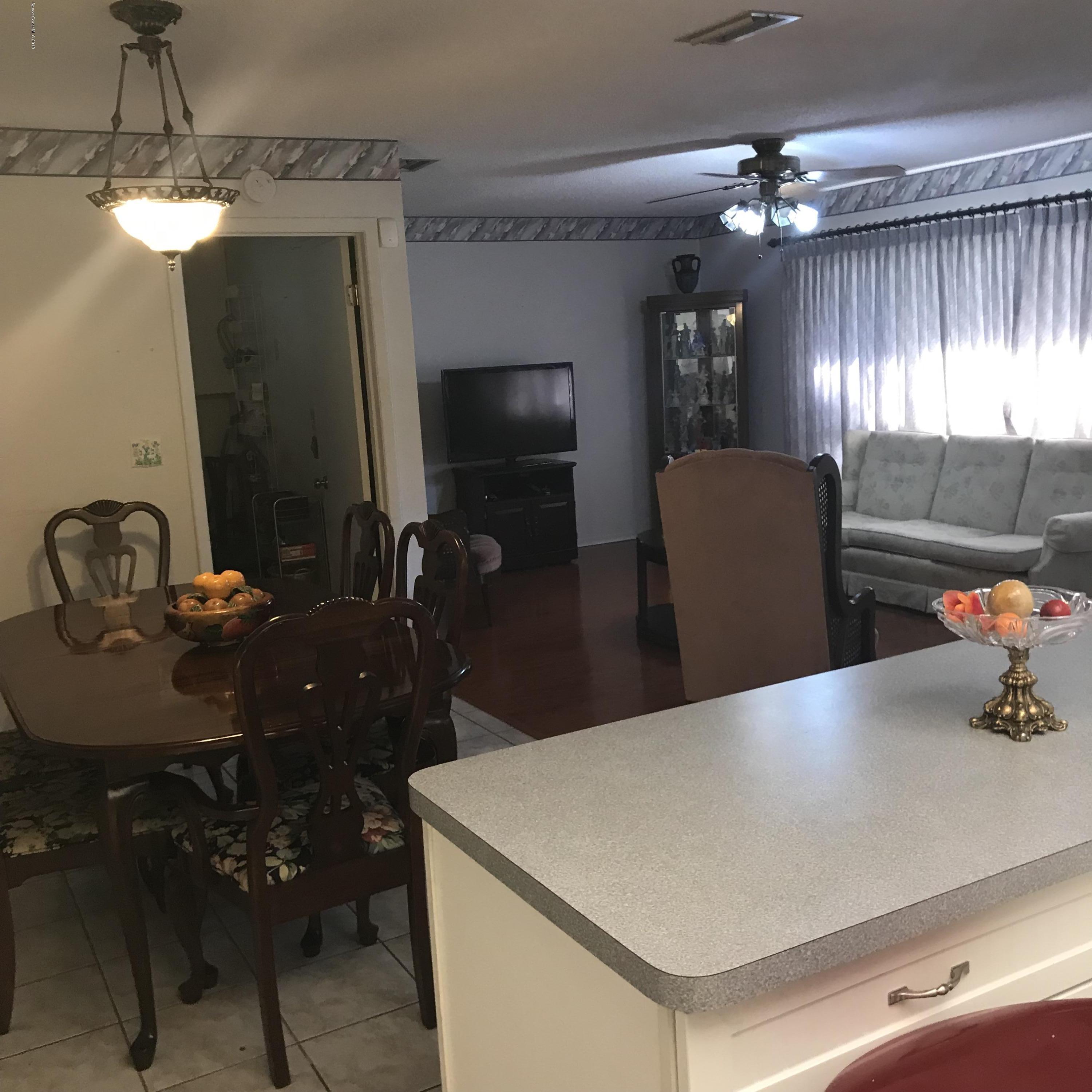 1350 Meadowbrook Road Northeast Palm Bay, FL 32905 - Photo 43 of 55 a living room with furniture and a chandelier