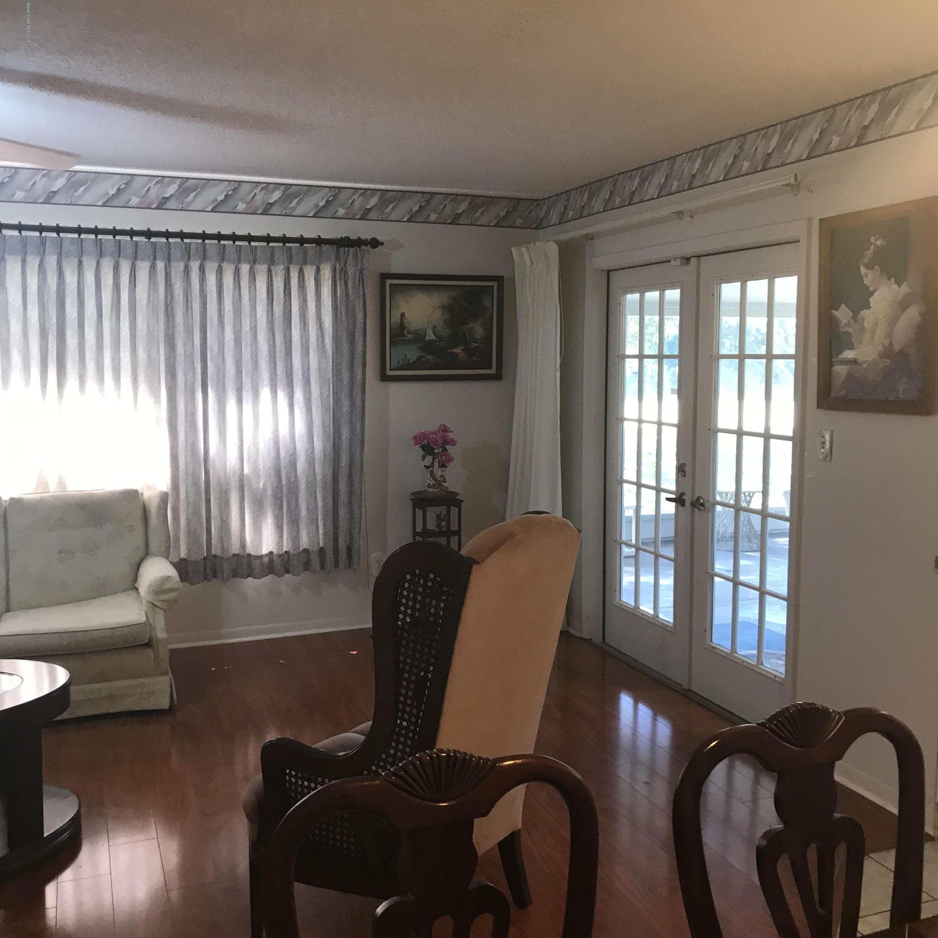1350 Meadowbrook Road Northeast Palm Bay, FL 32905 - Photo 47 of 55 a living room with furniture and a large window