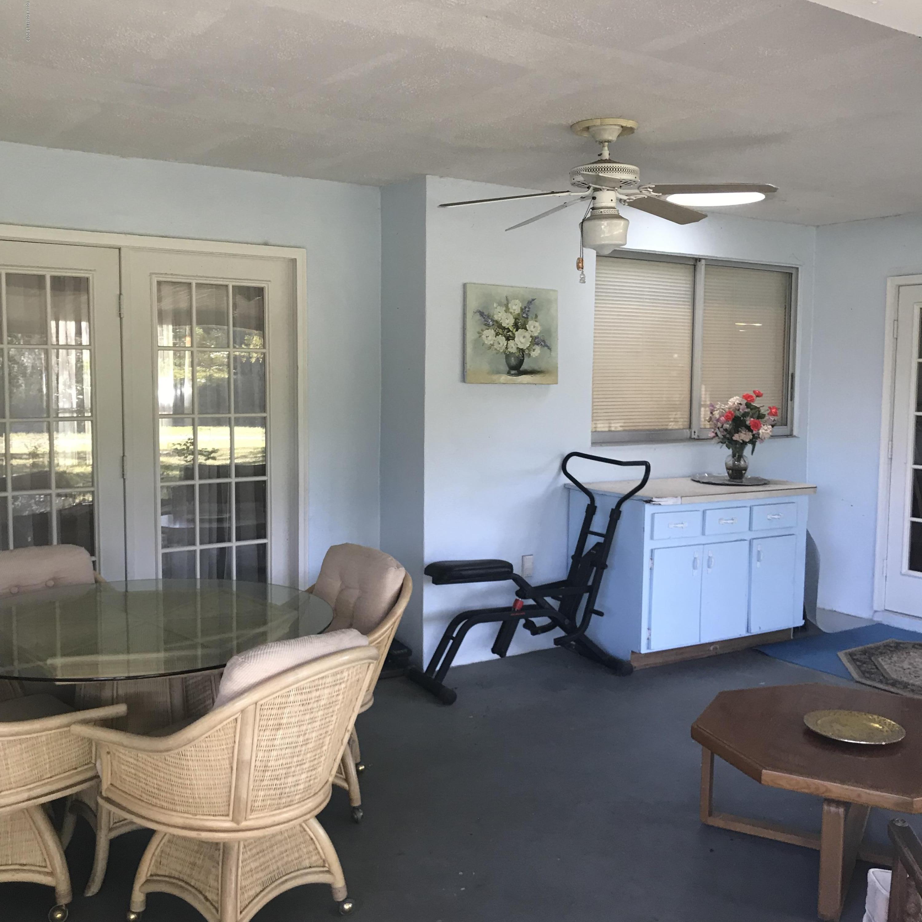 1350 Meadowbrook Road Northeast Palm Bay, FL 32905 - Photo 51 of 55 a living room with furniture and a window