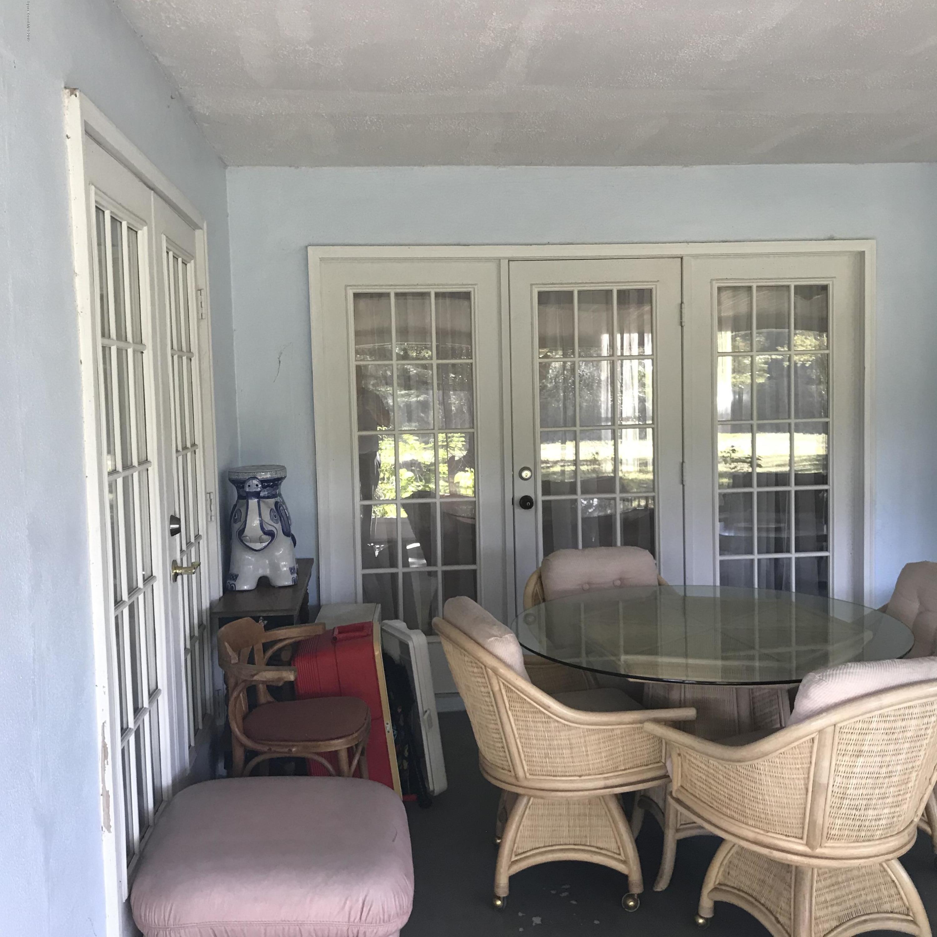 1350 Meadowbrook Road Northeast Palm Bay, FL 32905 - Photo 52 of 55 a living room with furniture and a floor to ceiling window
