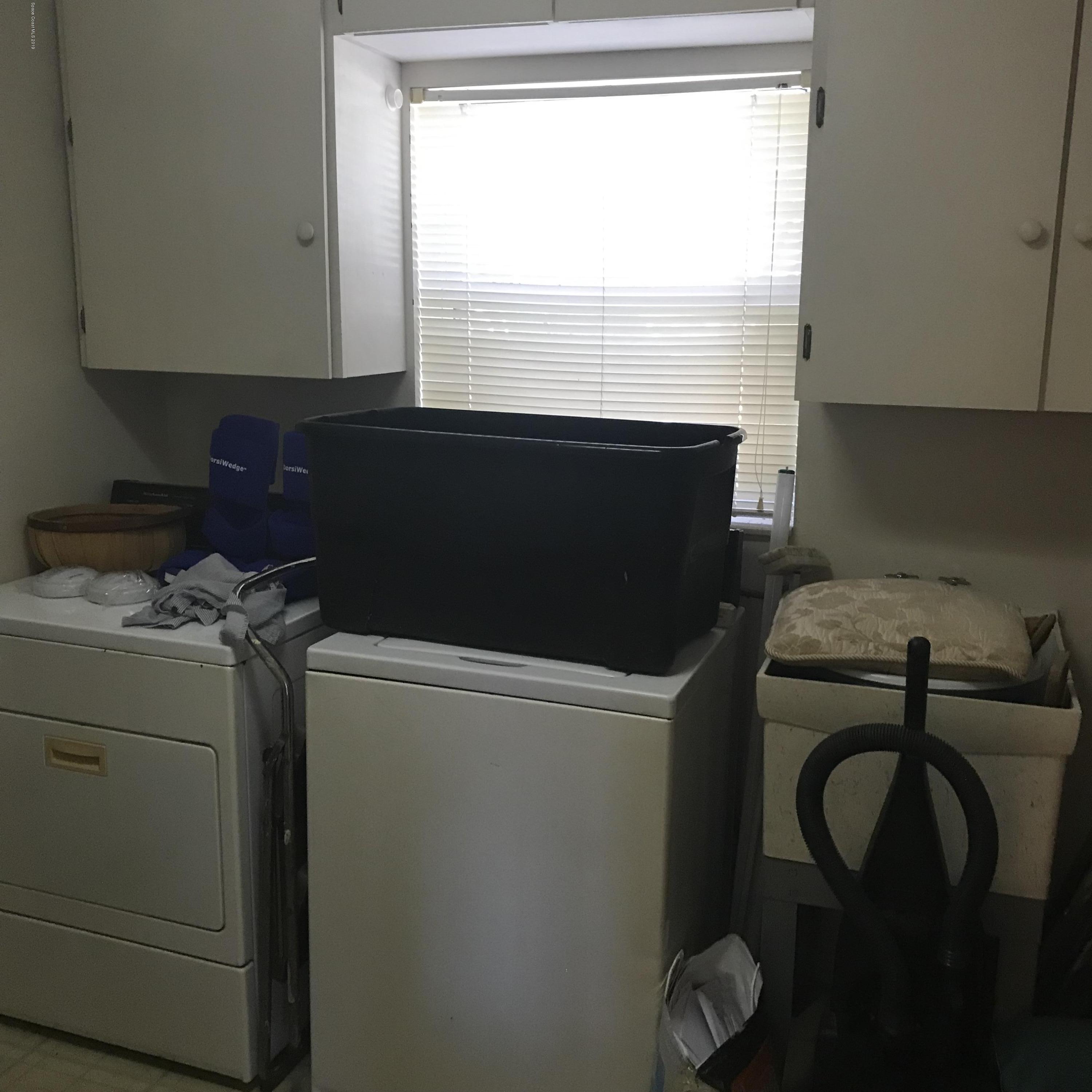 1350 Meadowbrook Road Northeast Palm Bay, FL 32905 - Photo 55 of 55 a utility room with dryer and washer
