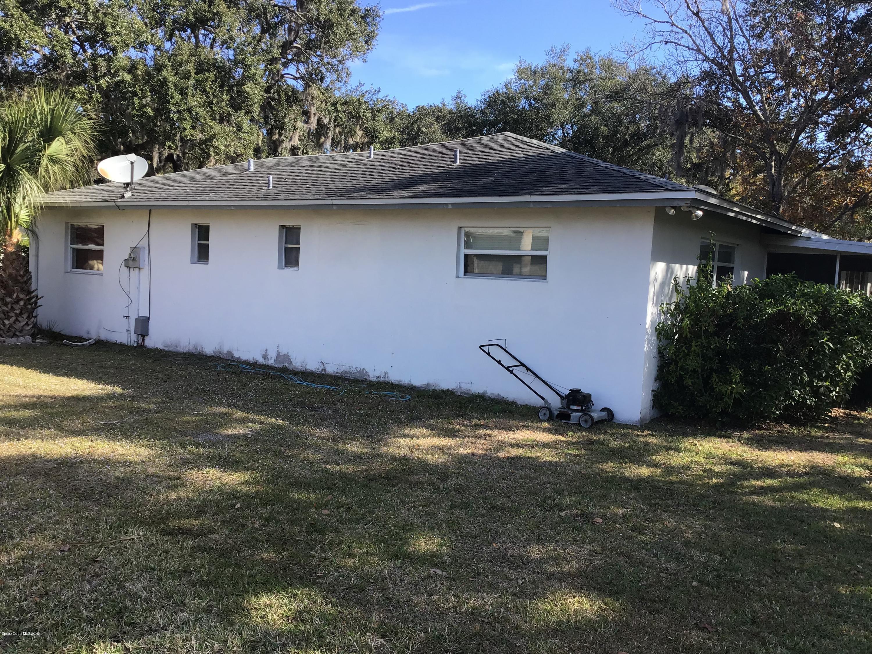 1350 Meadowbrook Road Northeast Palm Bay, FL 32905 - Photo 9 of 55 a backyard of a house with yard and garage
