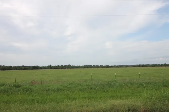 a view of a lake with houses in the background