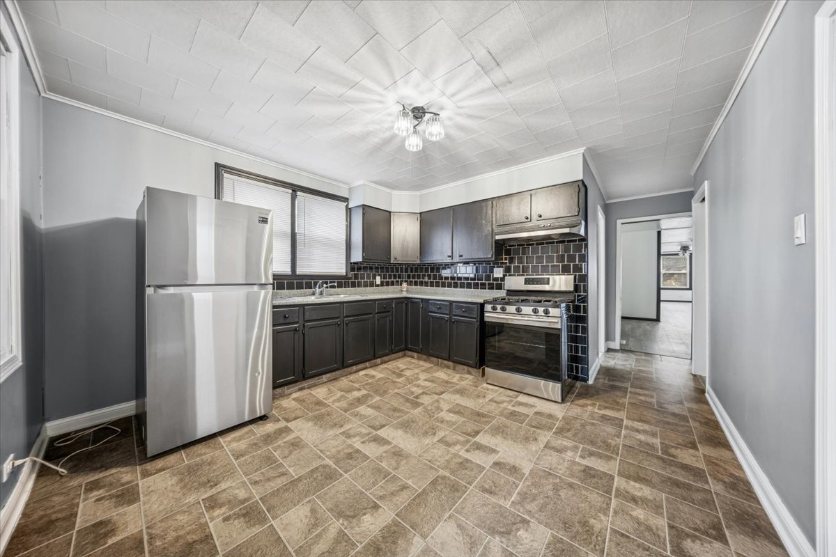 3134 West 39th Place, Unit 1 Chicago, IL 60632 - Photo 13 of 16 a kitchen with granite countertop a refrigerator stove and microwave
