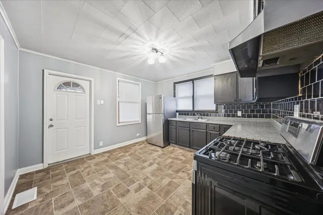a kitchen with a stove and a refrigerator