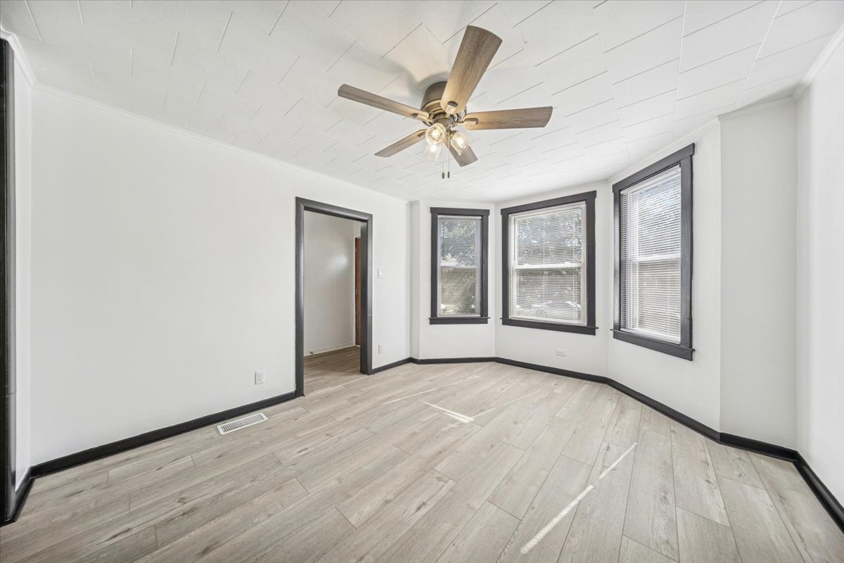 3134 West 39th Place, Unit 1 Chicago, IL 60632 - Photo 3 of 16 a view of an empty room with a window and wooden floor