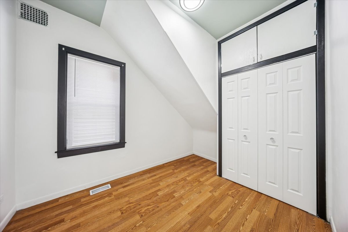 3134 West 39th Place, Unit 1 Chicago, IL 60632 - Photo 6 of 16 a view of empty room with wooden floor and fan