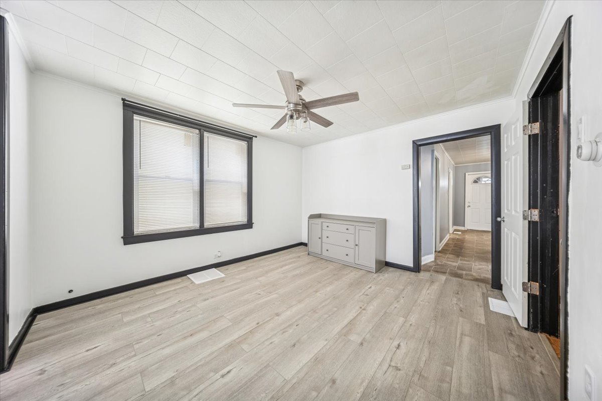 3134 West 39th Place, Unit 1 Chicago, IL 60632 - Photo 8 of 16 a view of an empty room with a window and wooden floor