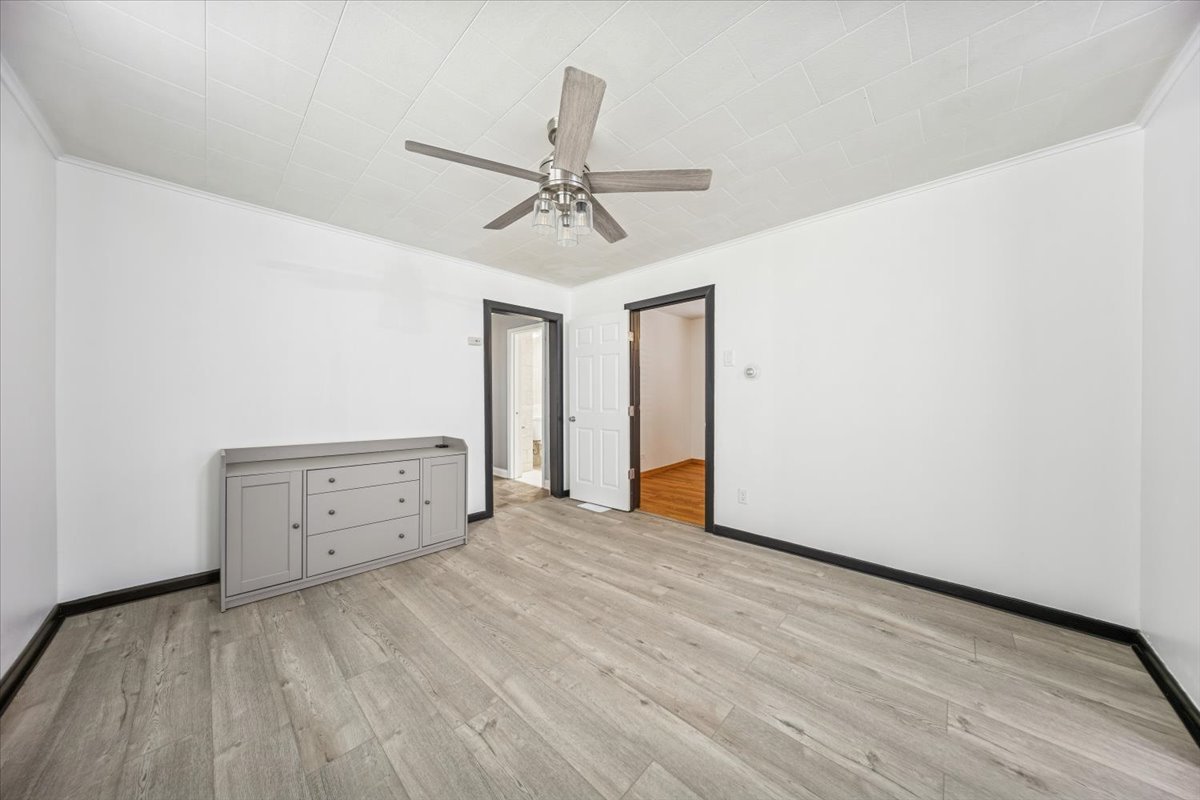 3134 West 39th Place, Unit 1 Chicago, IL 60632 - Photo 9 of 16 a view of an empty room with window and a ceiling fan