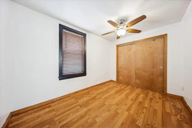 a view of a big room with closet and a ceiling fan