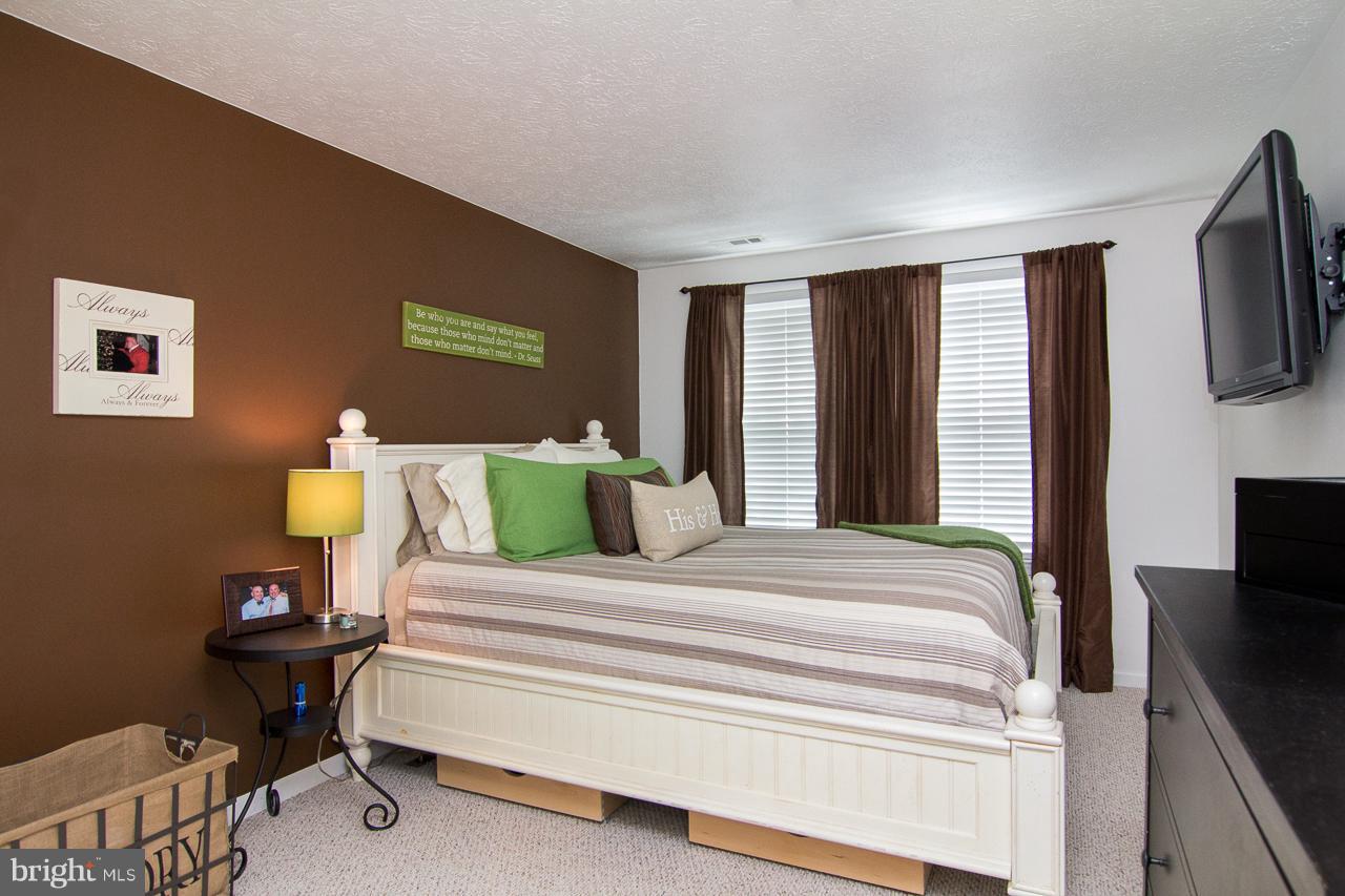 4122 Maple Path Circle, Unit 55 Baltimore, MD 21236 - Photo 16 of 27 a bedroom with a bed and tv