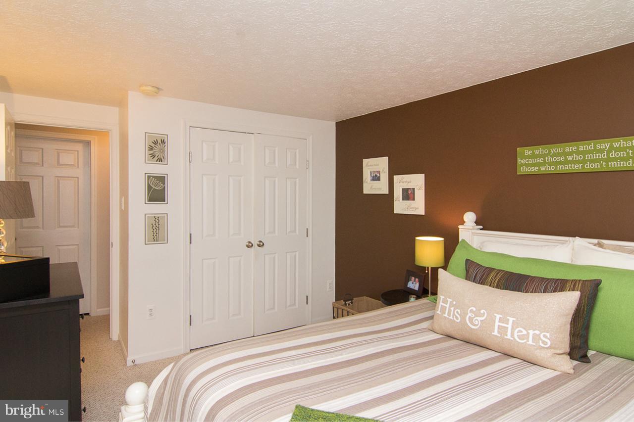 4122 Maple Path Circle, Unit 55 Baltimore, MD 21236 - Photo 17 of 27 a bedroom with a bed and wooden floor